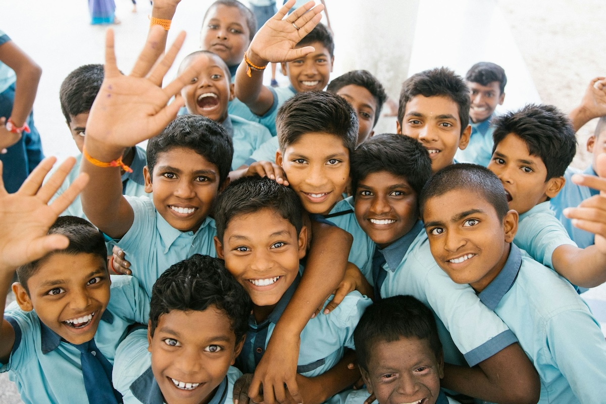 Happy kids waving at the camera